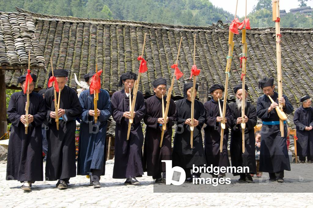China: Miao men playing the lusheng, a traditonal Miao instrument, in the village of Langde Shang, southeast of Kaili, Guizhou Province