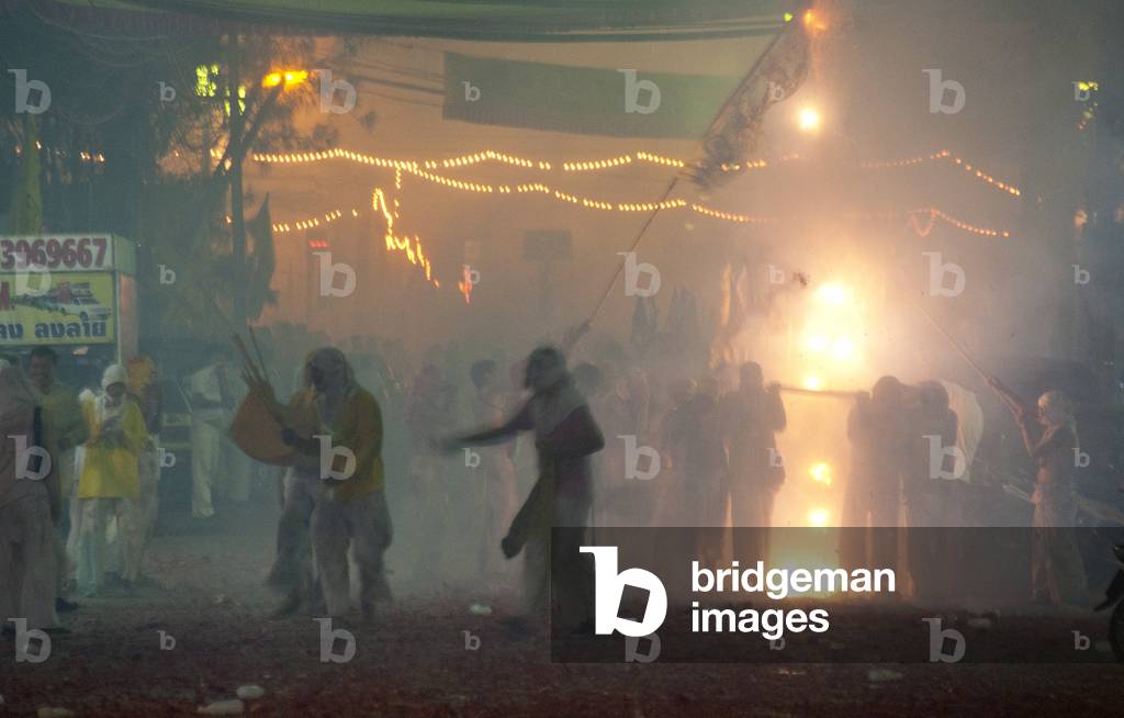 Thailand: The streets of Phuket Town exploding with firecrackers as the parade passes, Phuket Vegetarian Festival