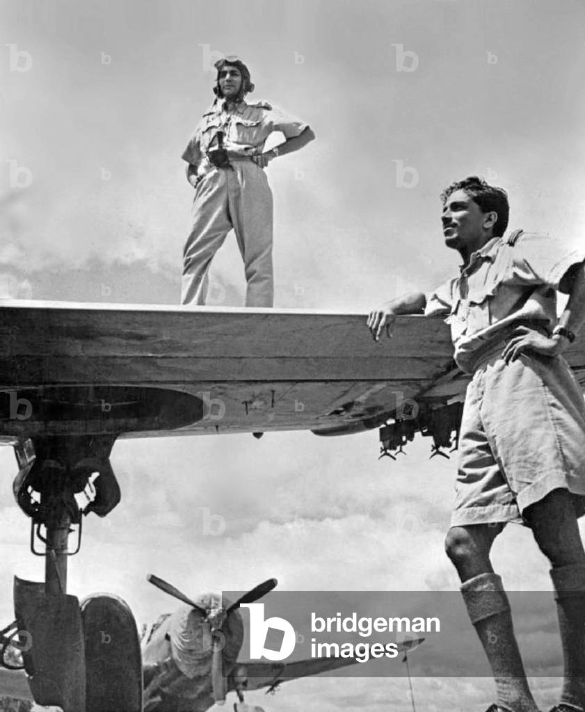 Burma / Myanmar / India: Two Indian Air Force pilots pose with their US-built Vultee A-31 Vengeance dive bombers at an air base from where they attacked the Japanese during the Burma Campaign. Assam, December 1943 (photo)