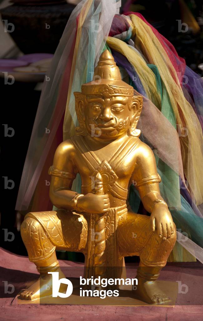 Thailand: Statue on the small spirit house next to the old wooden viharn, Wat Phan Tao, Chiang Mai