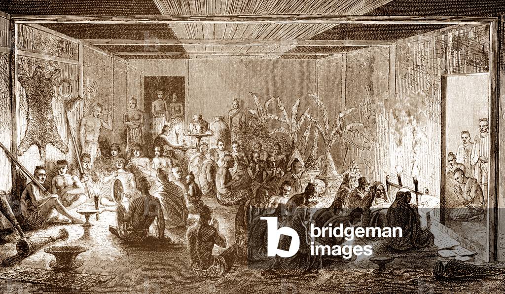 Laos: A French expedition prepares its baggage the night before a trip, while Buddhist monks pray for a safe passage, 1867.