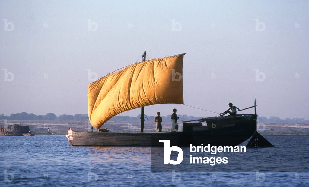 India: A local boat in the early morning on the River Ganges, Varanasi