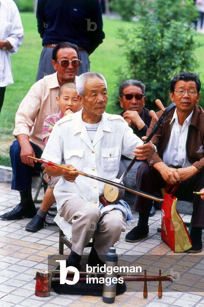 China: A man plays a banhu in a park in Wuwei, Gansu Province