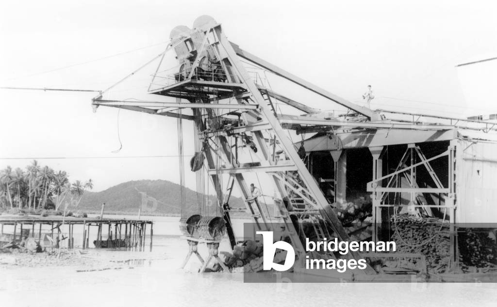 Thailand: A tin dredger belonging to Tongkah Harbour Company operating in the vicinity of Saphan Hin, Phuket, 1957