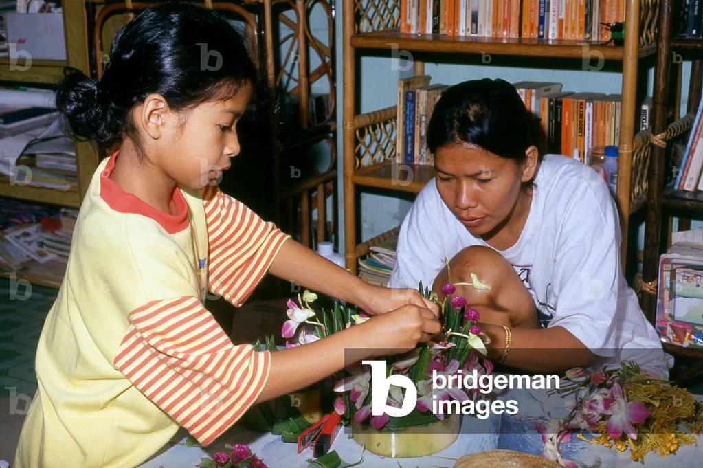 Thailand: Mother and daughter making krathongs, Loy Krathong Festival, Chiang Mai