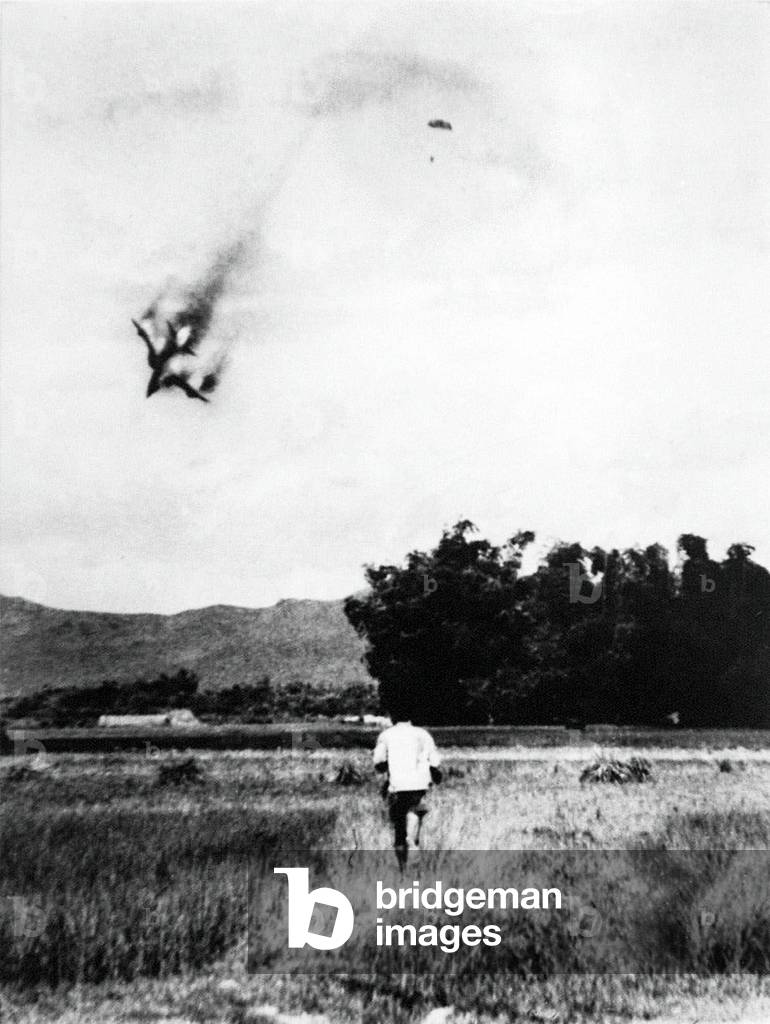 Vietnam: A USAF F-105 warplane is shot down near Vinh Phuc, North Vietnam, in September 1966. The pilot can be seen parachuting to safety - and captivity