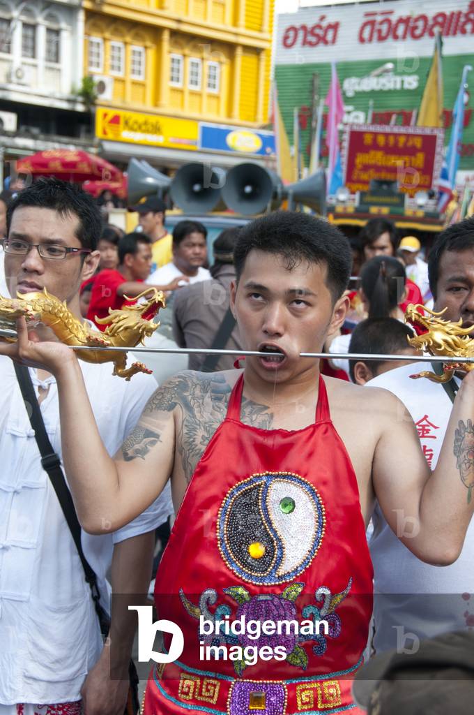 Thailand: Entranced devotee or 'Ma Song' takes part in a procession through Phuket Town, Phuket Vegetarian Festival