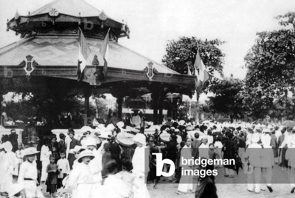 Vietnam: A crowd gathers at the bandstand near City Hall, Hanoi (early 20th century).