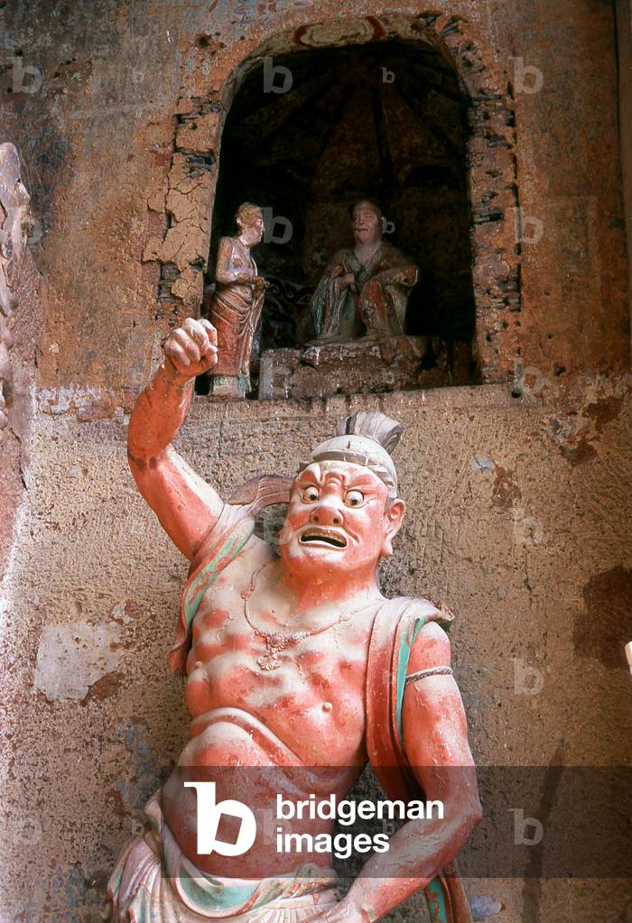 China: Warrior statue protecting a cave, Maiji Shan Grottoes, Tianshui, Gansu Province