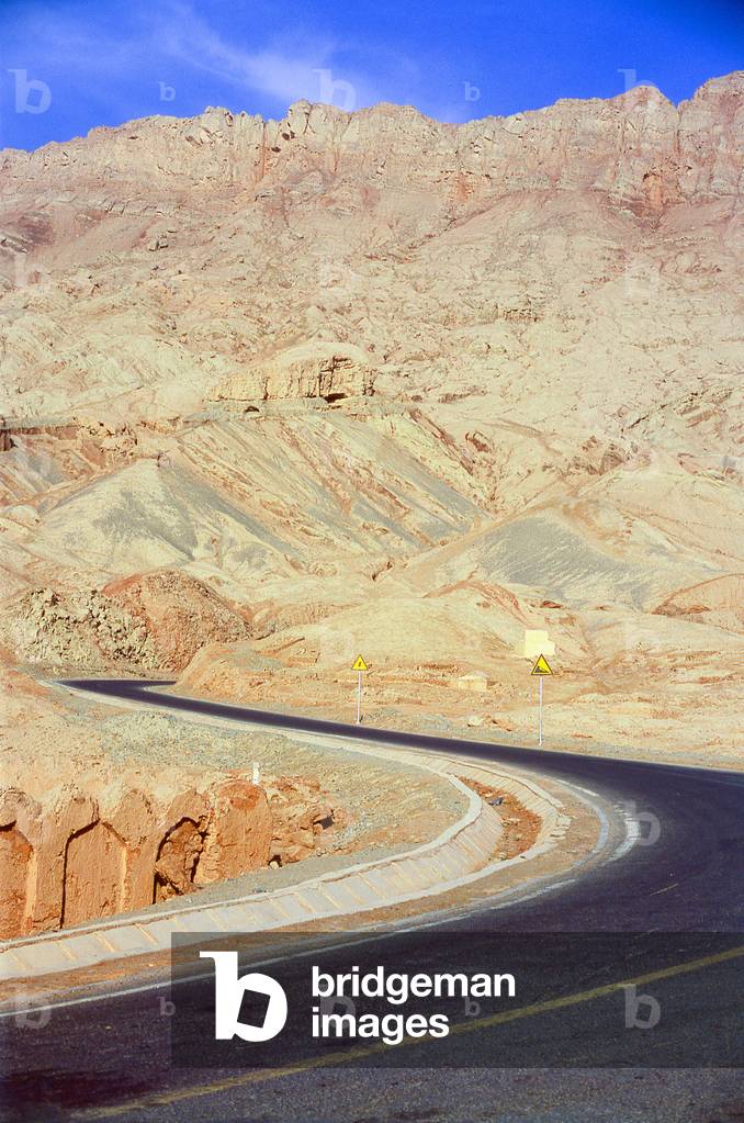 China: Road running next to the village of Tuyoq near Turpan, Xinjiang Province