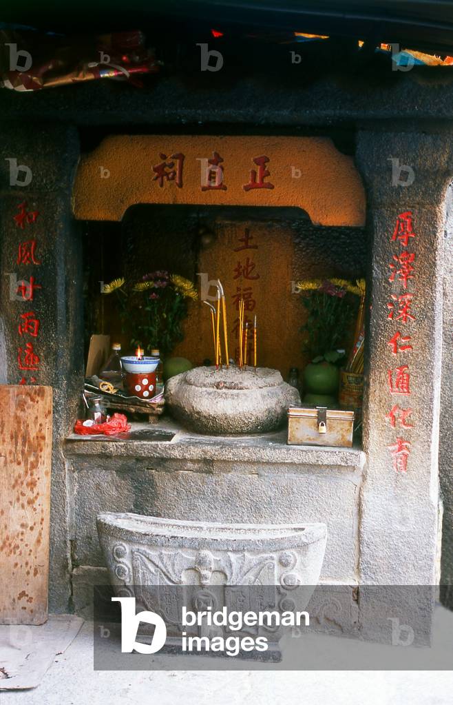 China: Incense burns in a corner shrine at the Taoist Temple da A-Ma, Macau