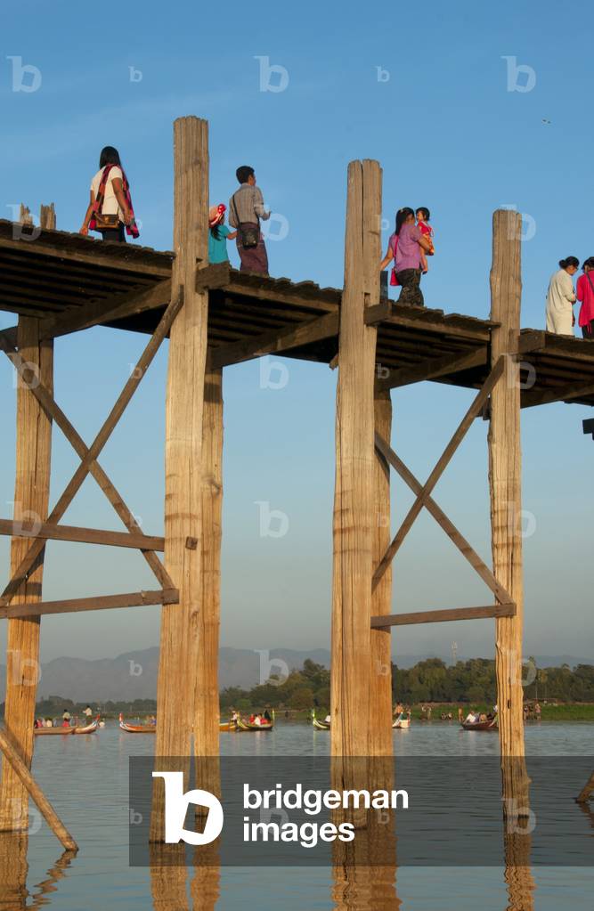 Burma / Myanmar: People gather to watch the sunset on the U Bein Bridge, the longest teakwood bridge in the world, Taungthaman Lake, near Amarapura, Mandalay