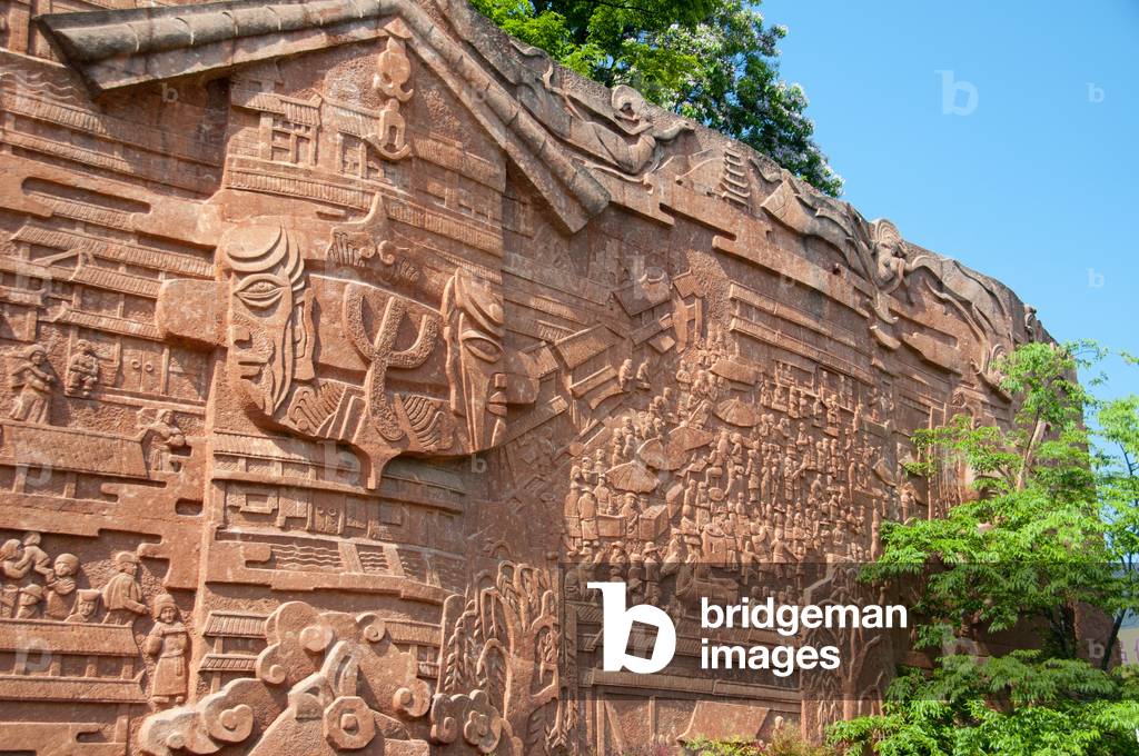 China: Naxi myths and legends portrayed on a wall at the edge of Lijiang Old Town, Yunnan Province