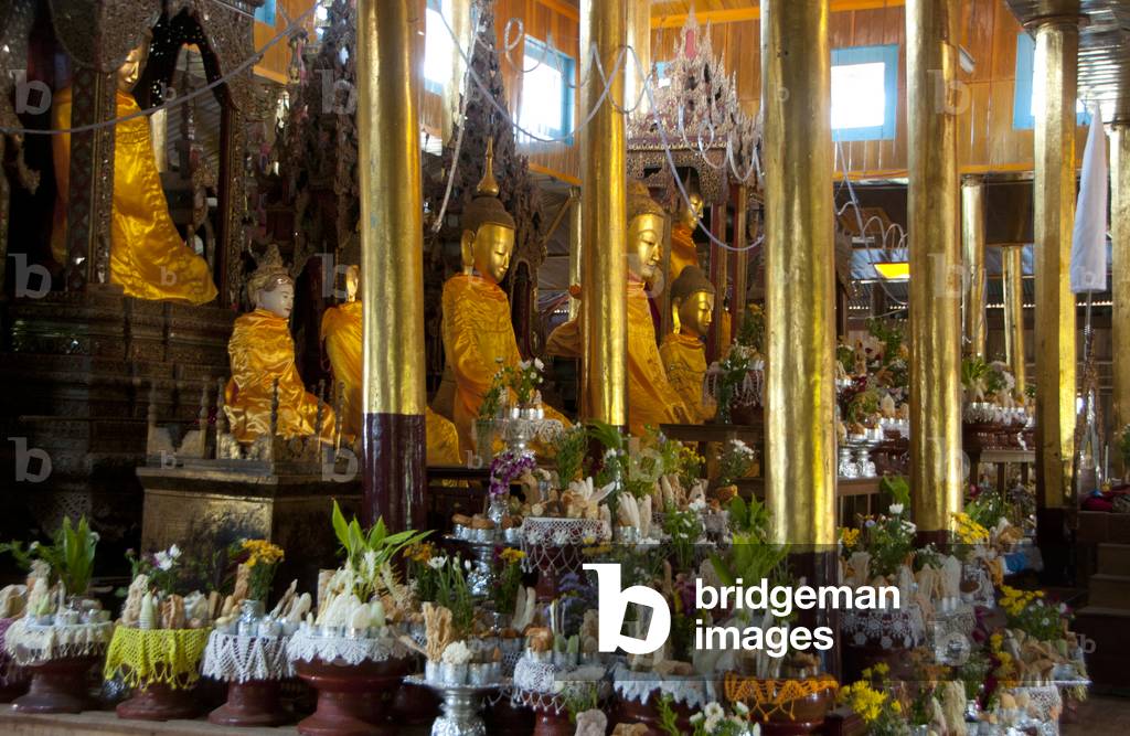 Burma-Myanmar: Food offerings in front of the Shan-style Buddhas at the May Nigone Mon Monastery, Inle Lake