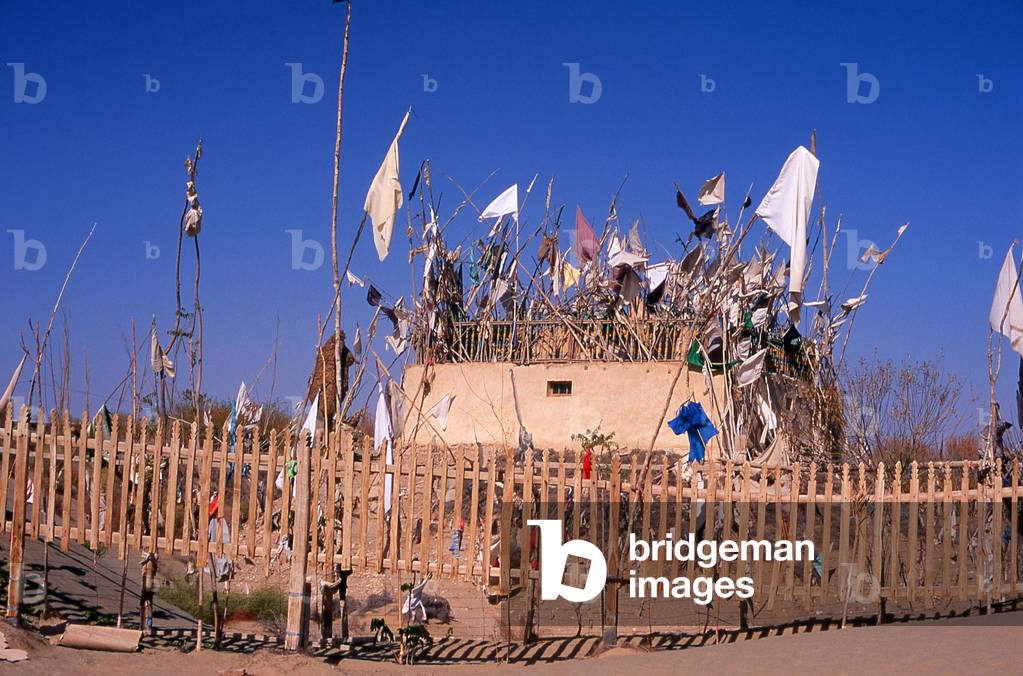 China: A tomb in the sand dunes near the Imam Asim Mazar (shrine) in the desert near Khotan, Xinjiang Province