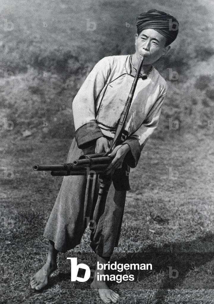 Laos: Hmong man playing the khene, Luang Prabang, 1888