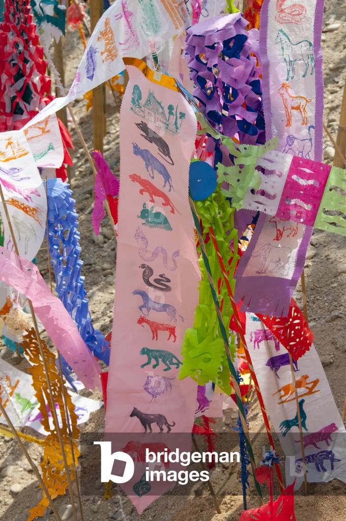 Thailand: Astrological banners adorn the giant songkran sand chedi at Wat Chetlin, Chiang Mai