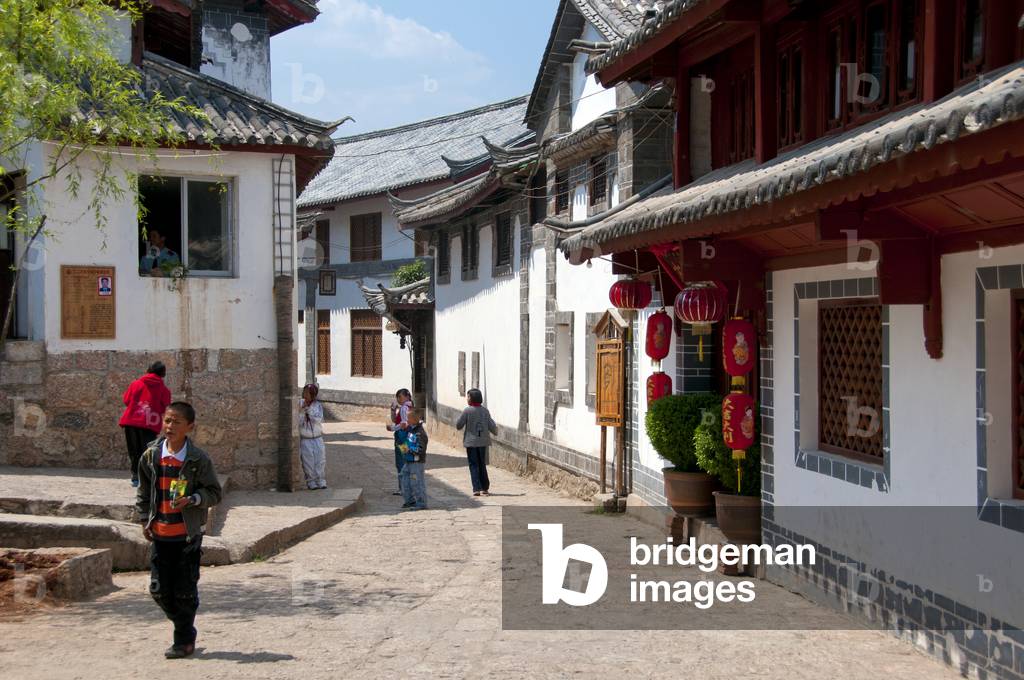 China: School children on a Lijiang Old Town back street, Yunnan Province