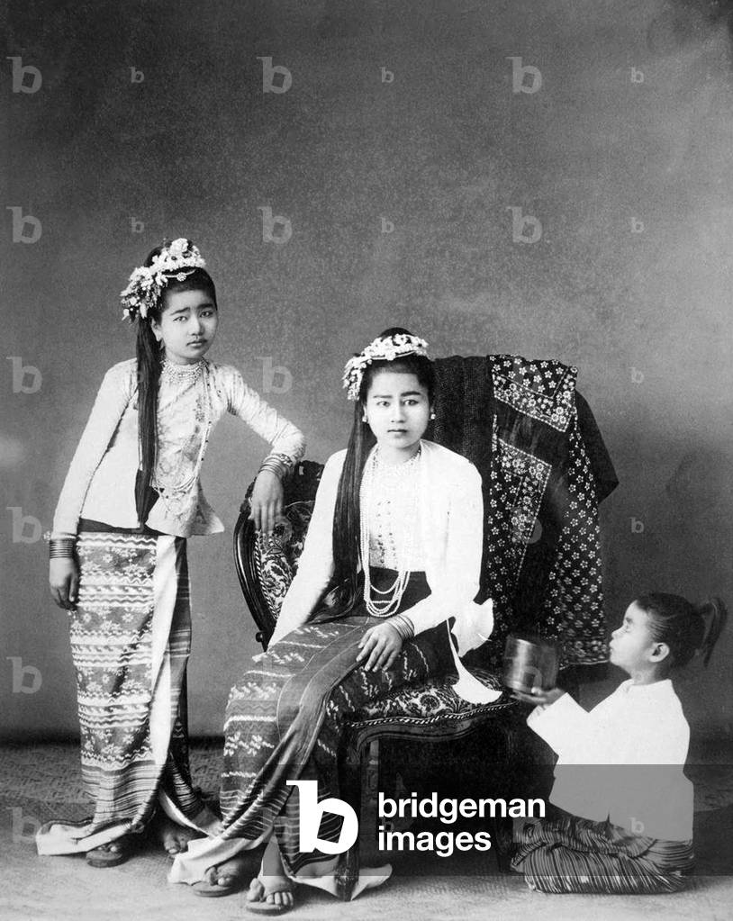 Burma / Myanmar: Studio portrait of two well-to-do young Burman women ('Burmese Princesses') with a young girl proffering a lacquer container. Felice Beato, probably Rangoon / Yangon, c. 1890