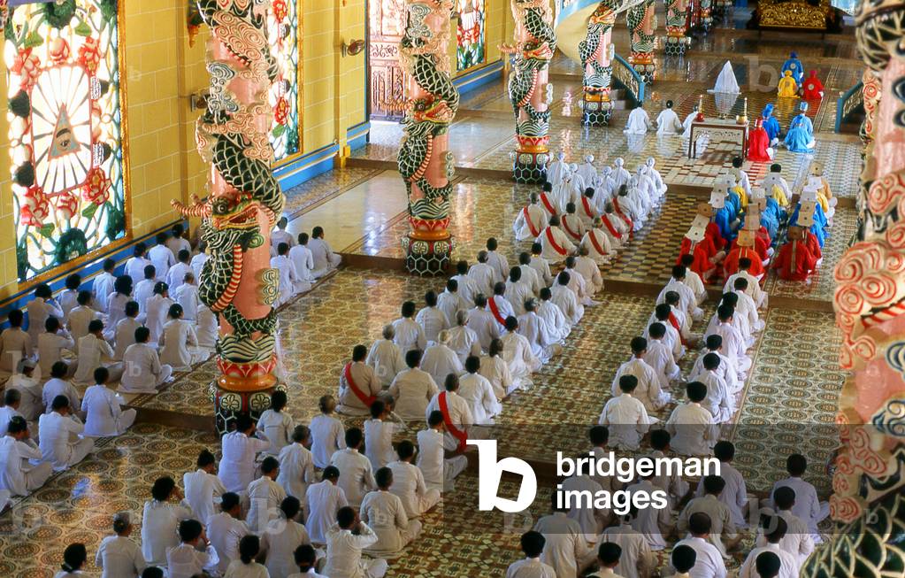 Vietnam: Monks (in coloured robes) and other adherents in the Cao Dai temple at the Cao Dai Holy See, Tay Ninh Province