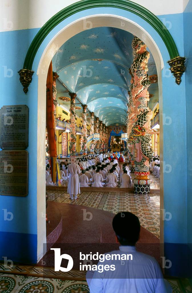 Vietnam: Monks (in coloured robes) and other adherents in the Cao Dai temple at the Cao Dai Holy See, Tay Ninh Province