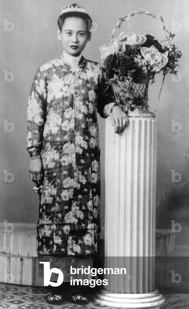 Thailand: A Phuket woman of Chinese ethnic origin poses in a Penang Nonya dress in this 1950 studio photograph
