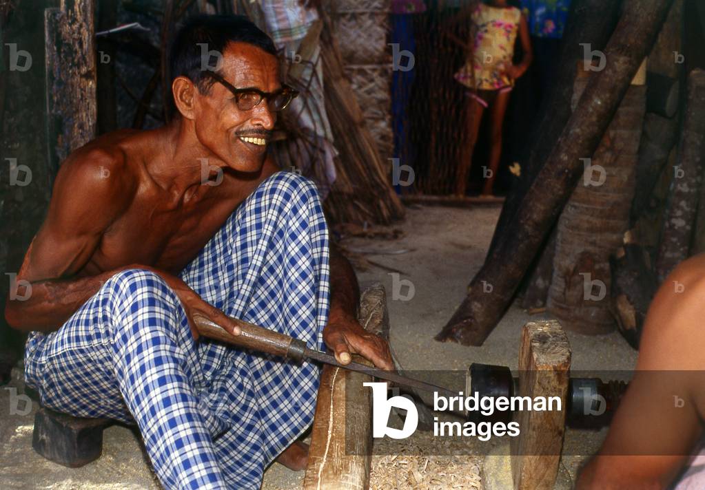 Maldives: Lacquer worker turning a new pot on a traditional lathe, Thulhaadhoo Island, Baa Atoll. This is the only island in the Maldives doing lacquer work, 1980