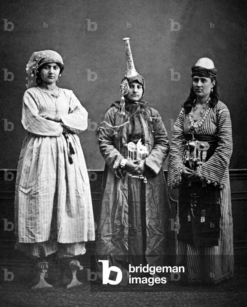 Syria: Three Syrian women, left to right urban Arab, Druze,rural Arab, Damascus (1873). The druze woman is wearing a tantour headdress