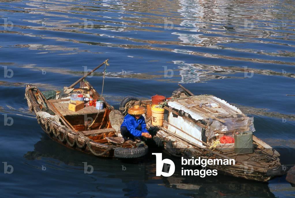 China: A Hakka woman with her ferry boat, Waisha Harbour, Beihai, Guangxi Province