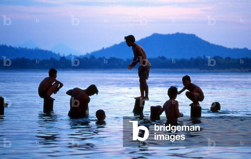 Burma / Myanmar: Bathing and swimming in the Irrawaddy / Ayeyarwady River at dusk near Mandalay
