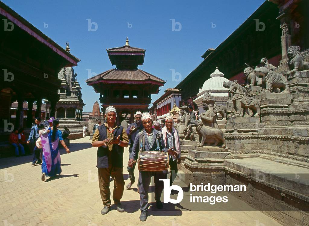 Nepal: Celebrating musicians walk passed the steps of the 17th century Siddhi Lakshmi Temple in Durbar Square, Bhaktapur (1997) (photo)