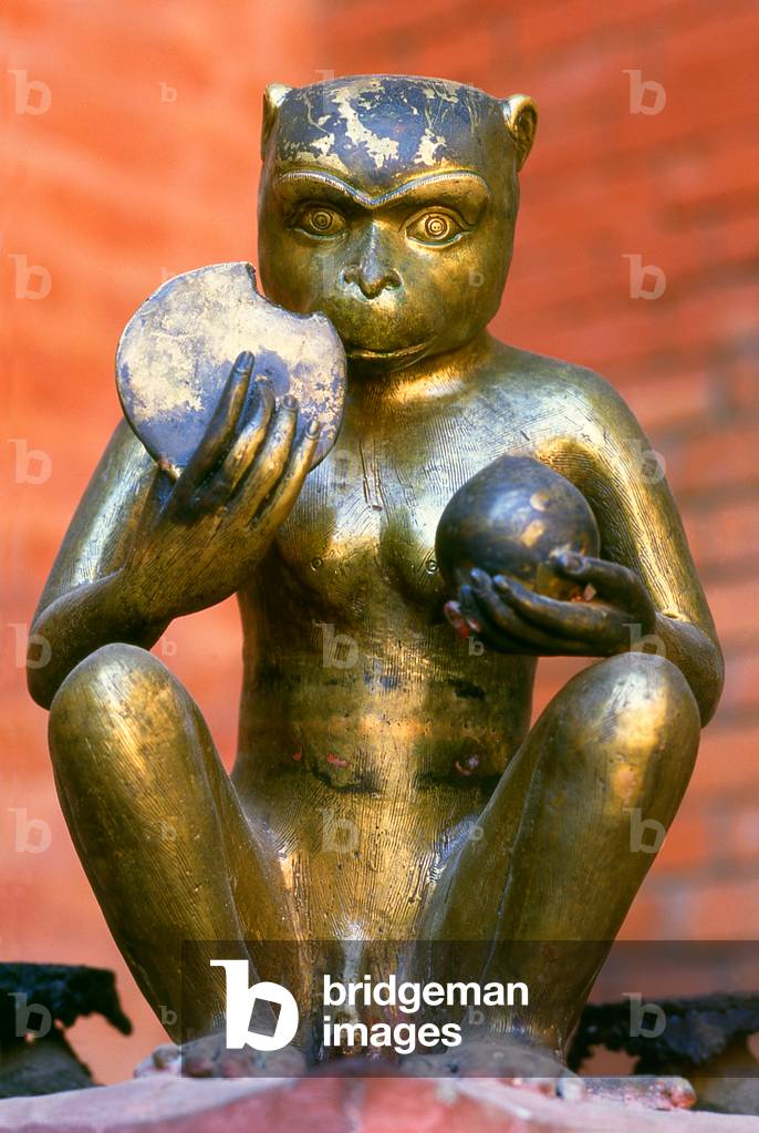 Nepal: A bronze statue of Hanuman, the Monkey King, Hindu god and devotee of Rama, eating a chapati (flat bread) at the Rudra Varna Mahavihar temple, Patan, Kathmandu Valley (1998)