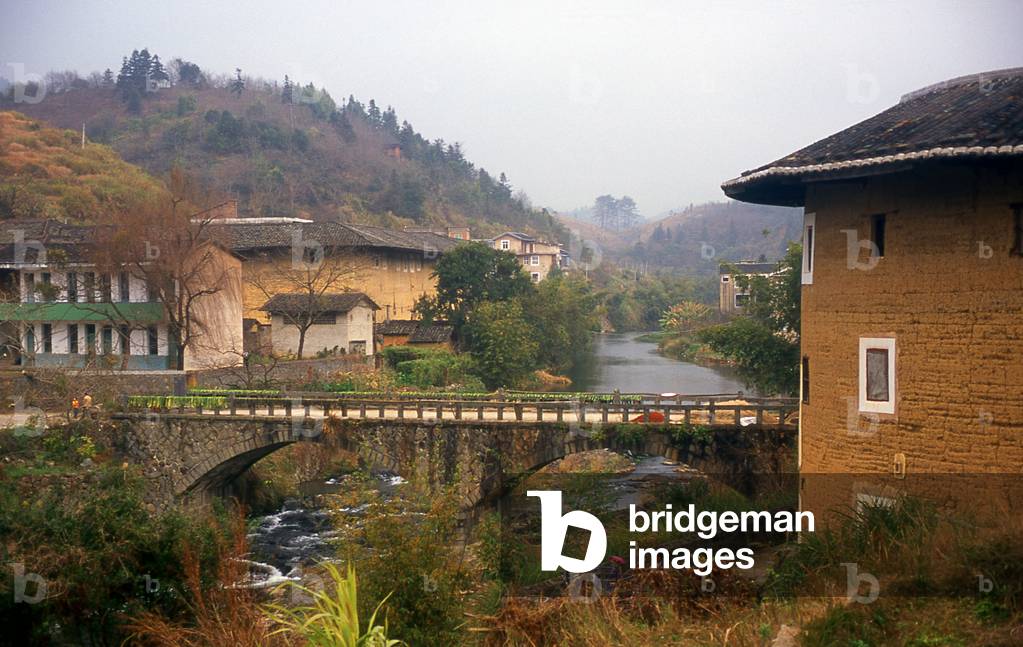 China: The bridge leading to Rusheng Lou (right), a small Hakka Tower near Hukeng, Yongding County, Fujian Province