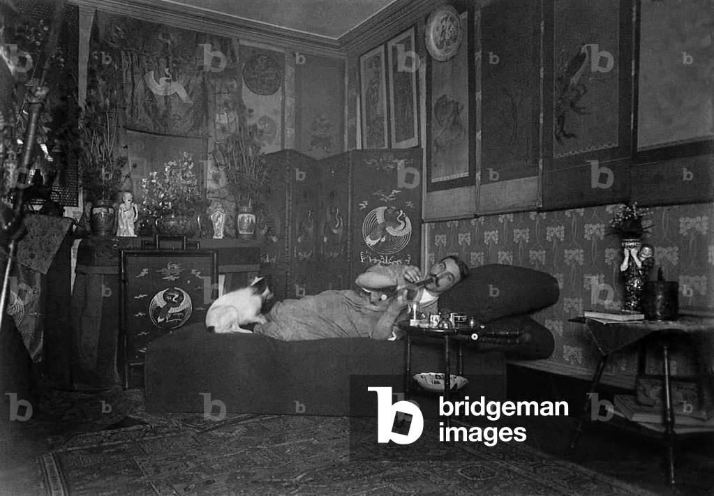 France: Opium smoker posing in an elaborately 'oriental' parlour, probably in France, early 20th century