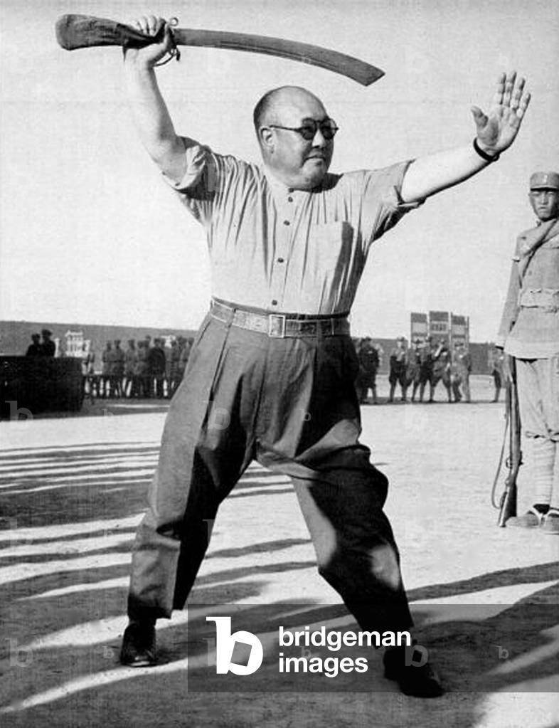 China: Chinese Muslim warlord Ma Hongkui (1892-1970) showing off his swordsmanship c. 1948.