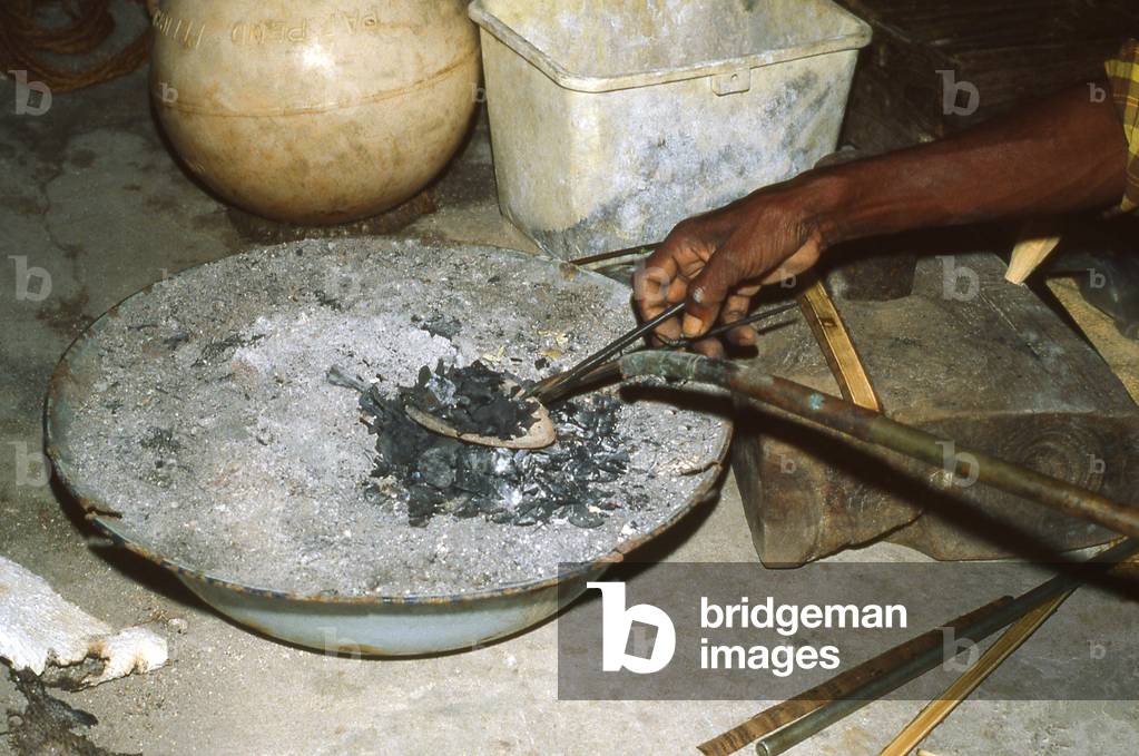 Maldives: A Hulhudheli Island silversmith uses a bellows to operate a blowpipe, South Nilandhoo Atoll, 1980