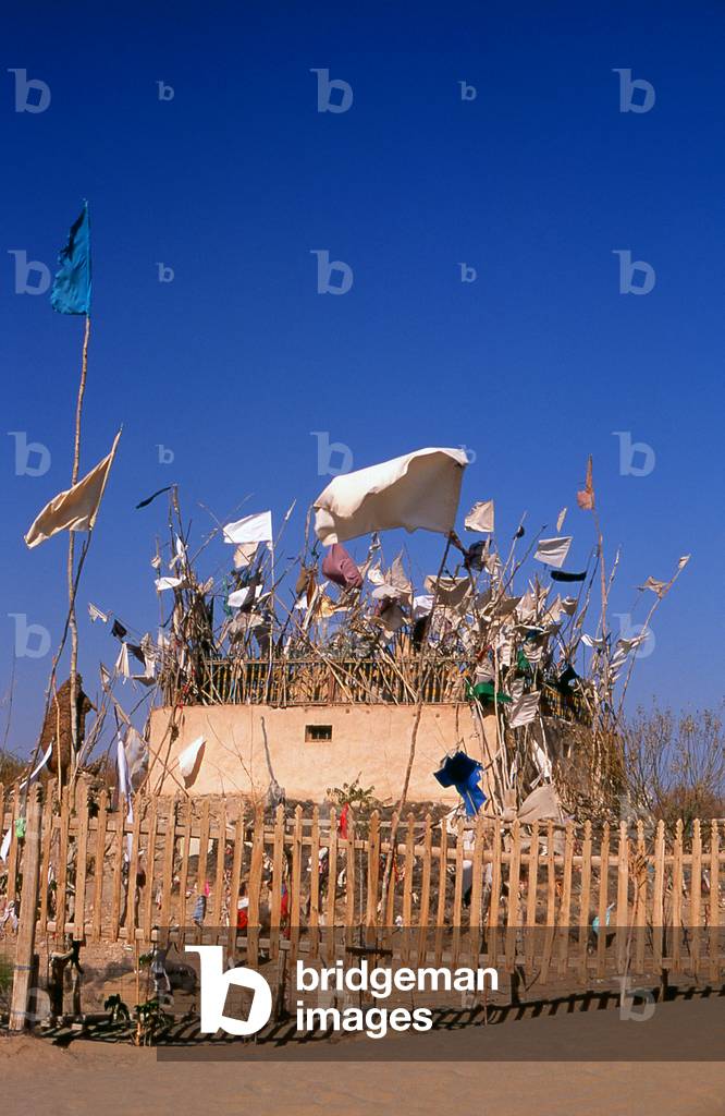 China: A tomb in the sand dunes near the Imam Asim Mazar (shrine) in the desert near Khotan, Xinjiang Province