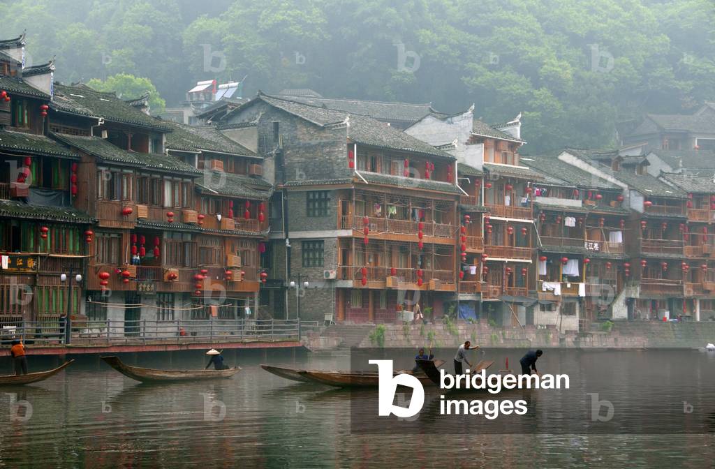 China: Boatmen early morning on Fenghuang's misty Tuo River, Fenghuang, Hunan Province