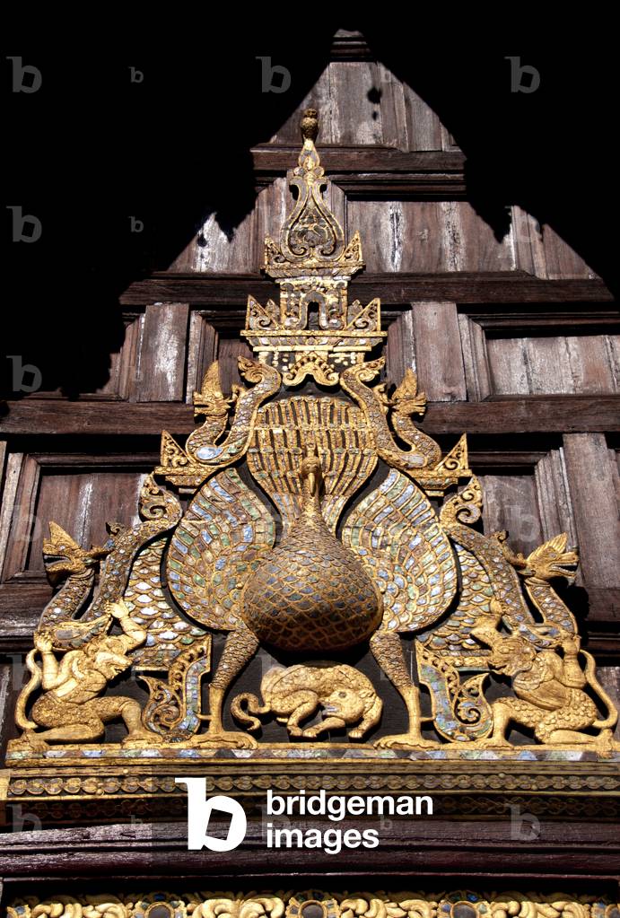 Thailand: The carved wooden peacock over the main entrance, Wat Phan Tao, Chiang Mai
