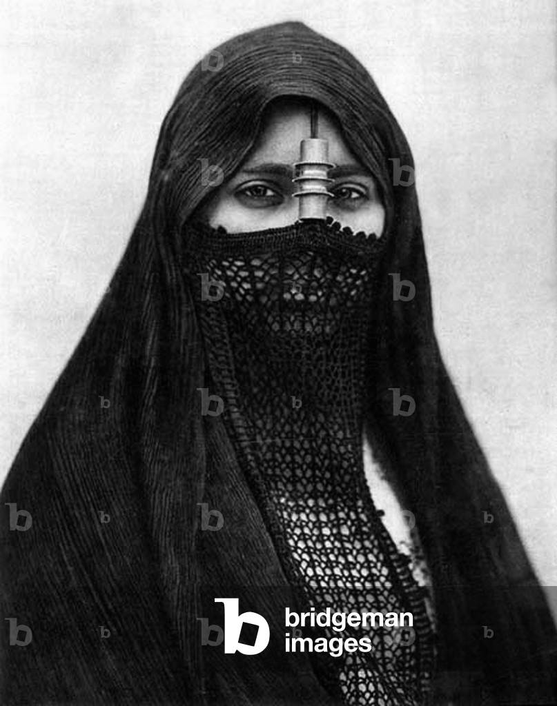 Algeria: Veiled Arab beauty, c. 1910.