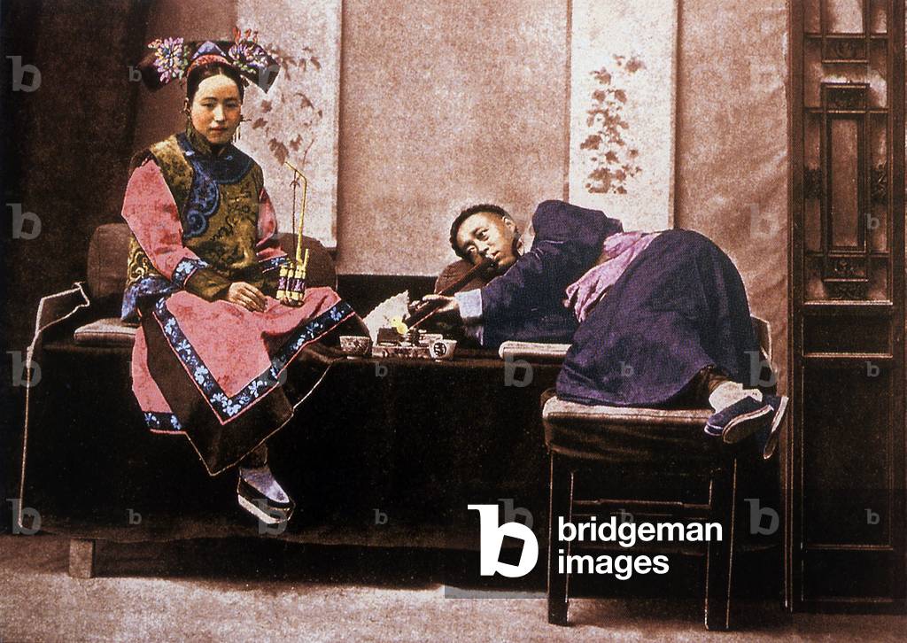 China: A posed picture of a Manchu man and woman smoking opium, late Qing Dynasty, c.1890