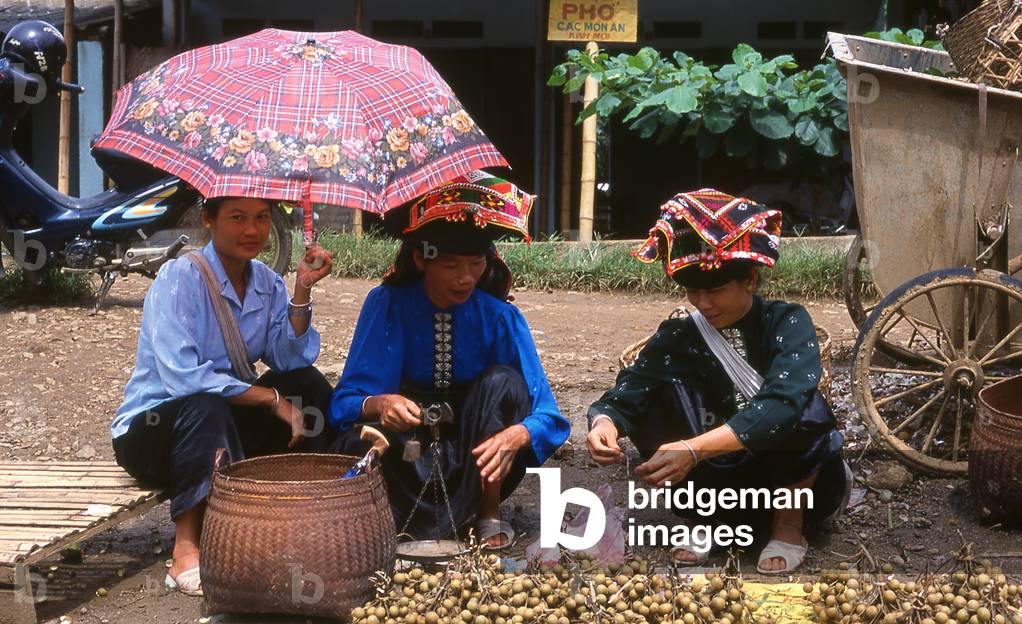 Vietnam: Tai women selling bunches of longan fruit in the market at Thuan Chau , Son La Province, Northwest Vietnam