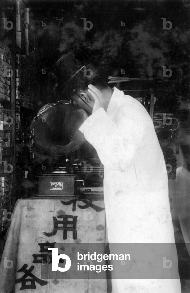 Korea: A well-to-do Korean man listening to a phonograph, Seoul, early 20th century