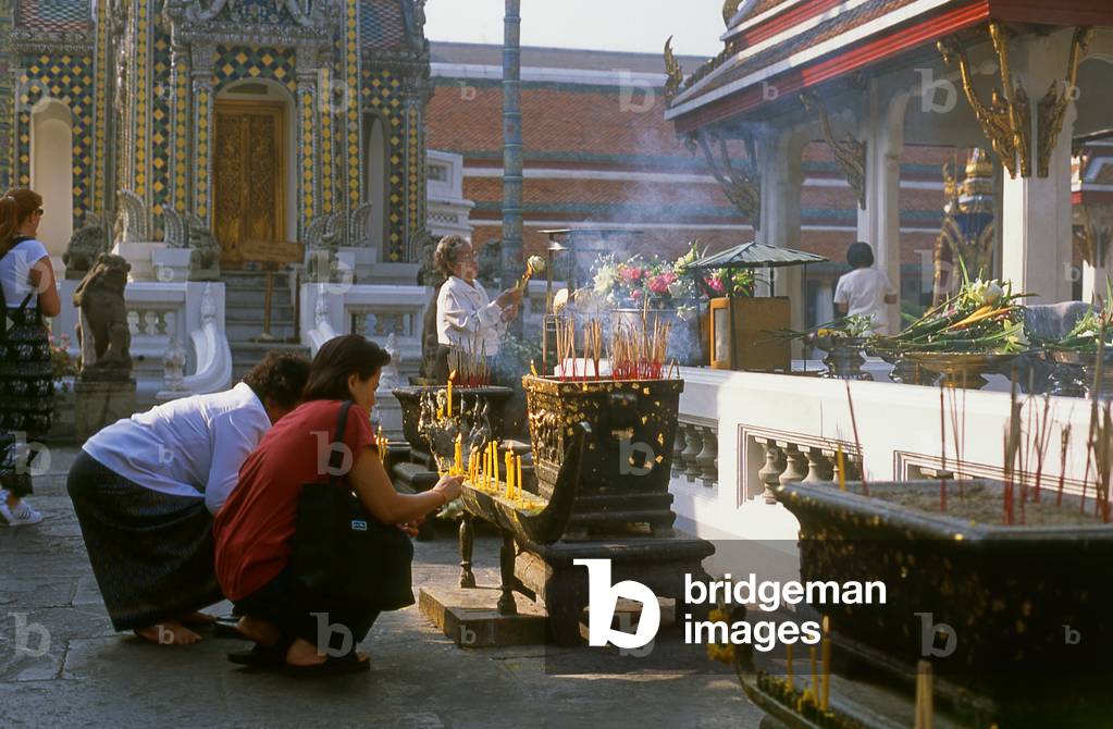 Thailand: People lighting incense at the Chao Mae Guan Im (Guanyin) shrine in front of the ubosot, Wat Phra Kaew (Temple of the Emerald Buddha), Bangkok (photo)