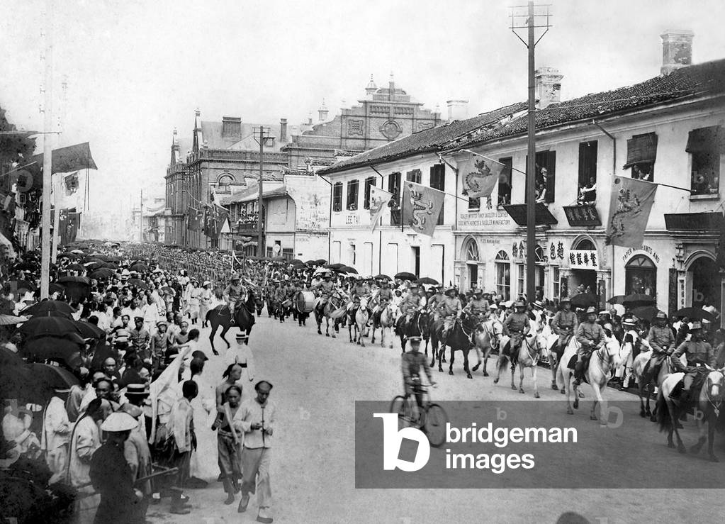 China: The Shanghai Volunteer Corps parading down Nanking (Nanjing) Road, 1902. The Shanghai Volunteer Corps were established in 1853, with the purpose of protecting the International Settlements