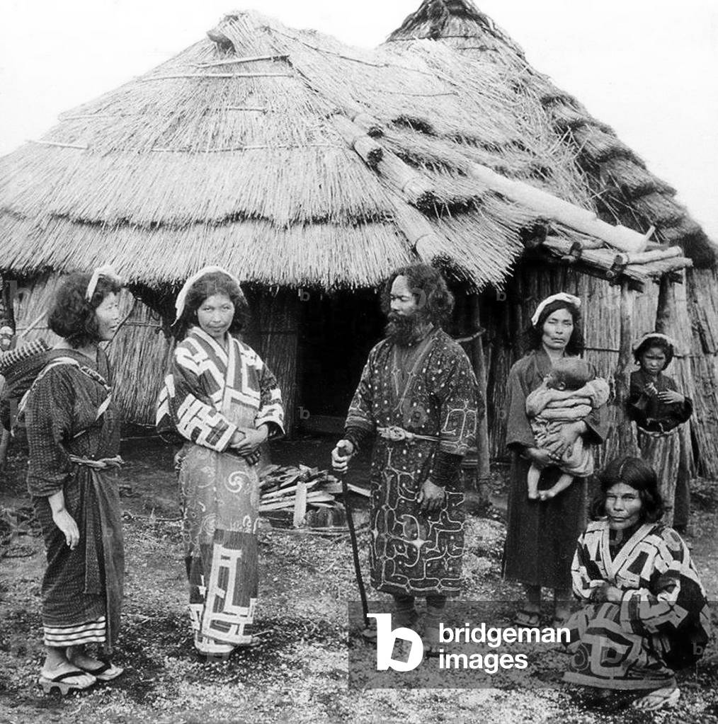 Japan: An Ainu family outside their home somewhere in Hokkaido, c. 1900 (b/w photo)