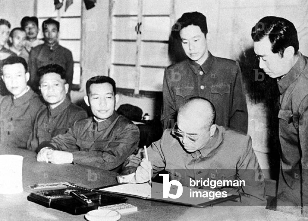 China / Korea: Peng Dehuai (1898-1974), Commander in Chief Chinese People's Volunteer Army in Korea, signs the 1953 armistace agreement ending the Korean War in Kaesong