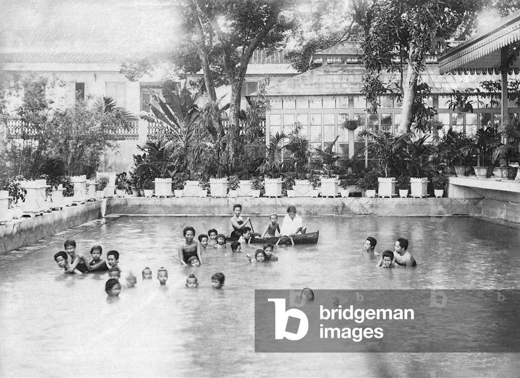 Thailand: Children of the Thai royal family swimming and playing in a swimming pool at a palace in Bangkok, 1880s.