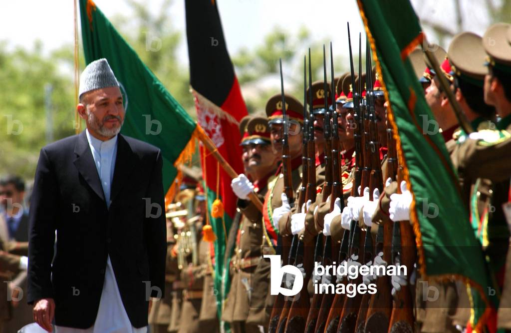 Afghanistan: Democratic Republic of Afghanistan President Hamid Karzai, reviewing afghan National army troops.