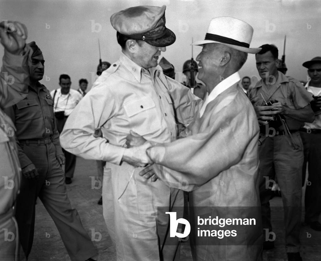 Korea: General Douglas MacArthur, Supreme Commander for Allied Powers, (Left) and Dr. Syngman Rhee, Korea's first President, greet one another upon the General's arrival at Kimpo Air Force Base, c. 1948